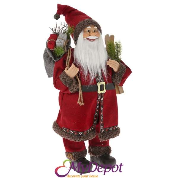 Дядо Коледа с бордо кадифен костюм носещ чифт ски, 60 см